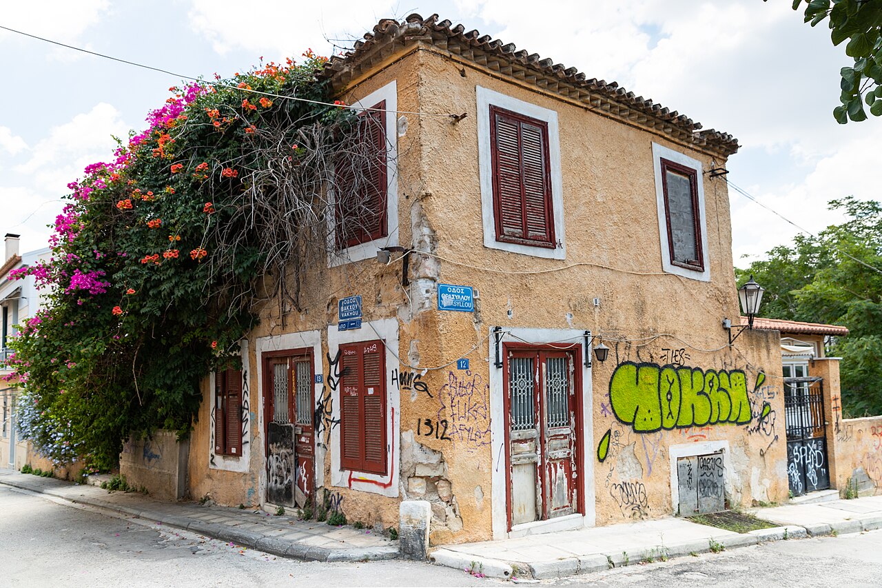 A colourful two-storey house with shutters in Plaka, Athens